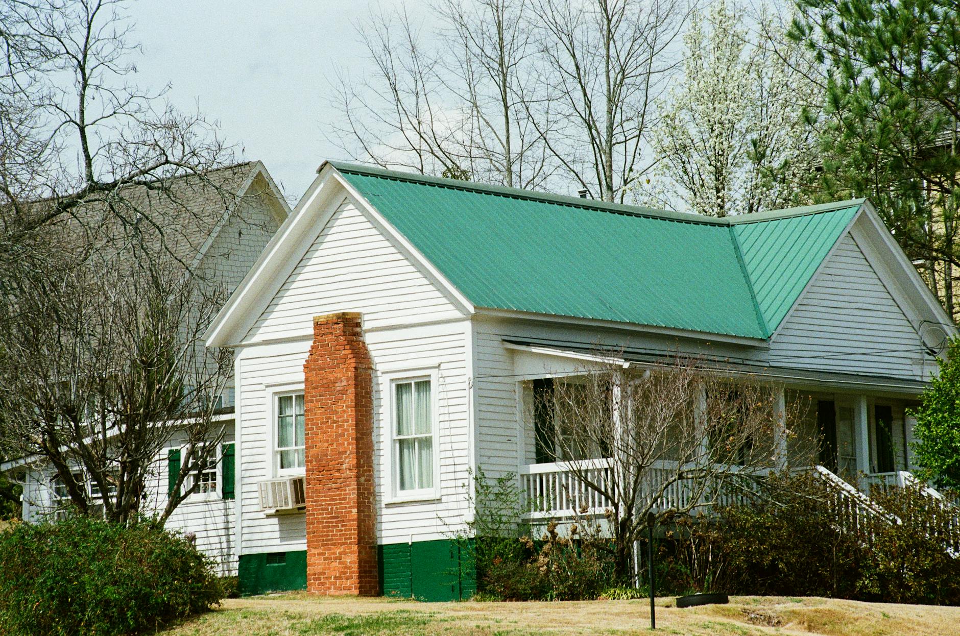 Side-by-side comparison of asphalt shingle and metal roofing